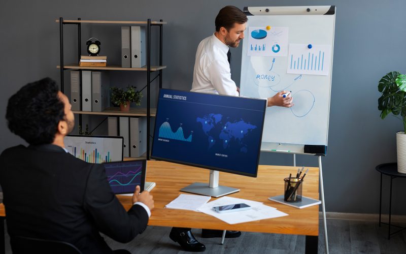 business-person-looking-finance-graphs 1