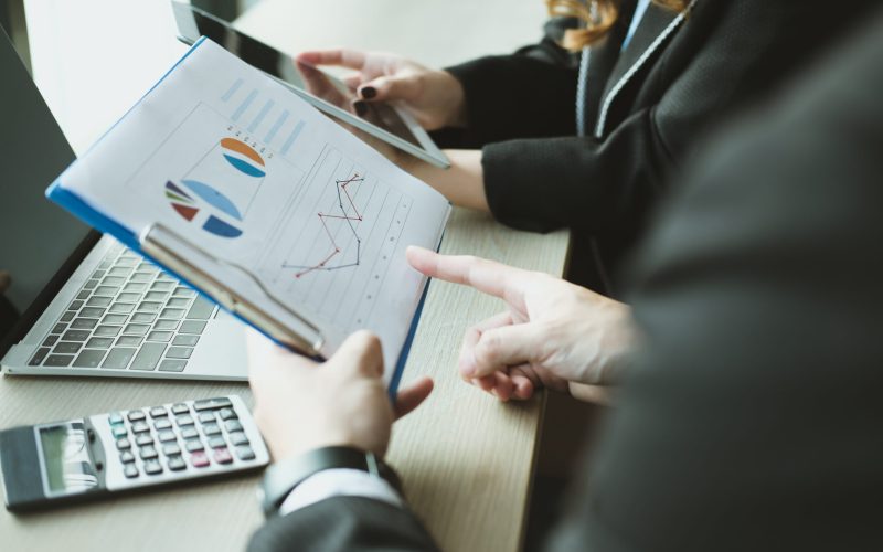 young business people having a meeting. businessman & businesswoman working with financial plan report at cafe. startup man & freelance woman discussing market data at coffee shop. discussion, teamwork, collaboration, corporate concept.